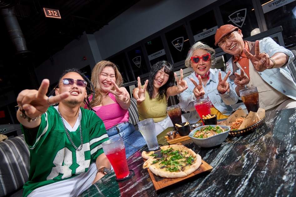 A group of people sitting at a table with food

Description automatically generated